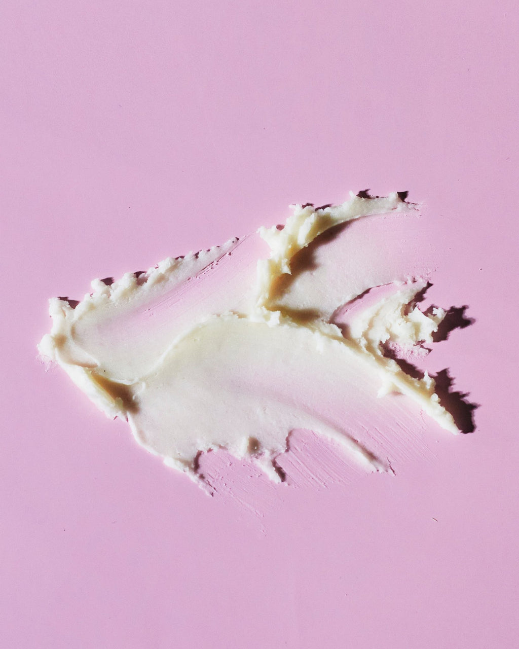 4. Close-up of smooth texture of Nurme natural deodorant on pink background
