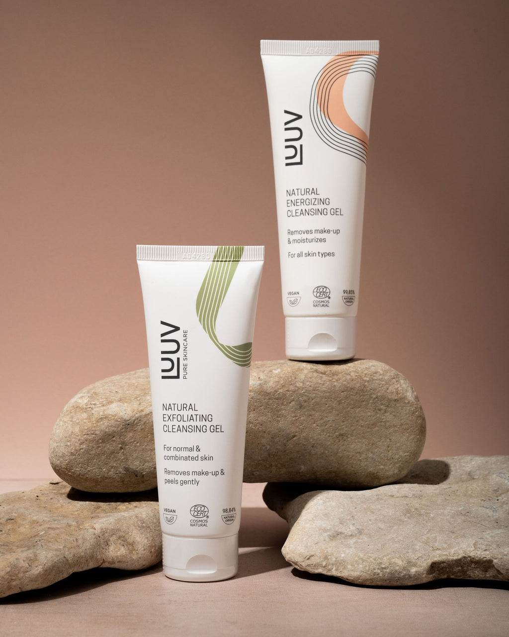 2. LUUV Natural Energizing and Exfoliating Cleansing Gel tubes on rocks with a pink background