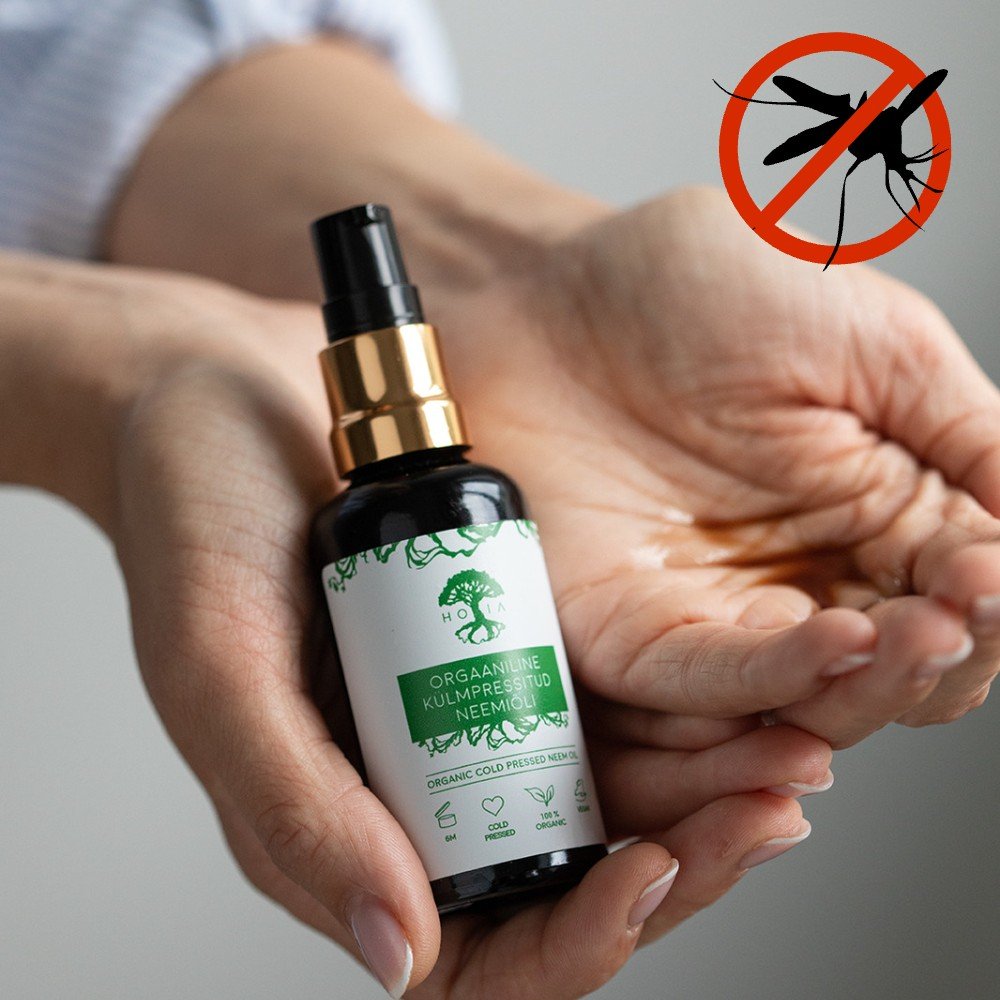 1. HOIA homespa natural insect repellent neem oil in use, showing application on hands with anti-mosquito symbol