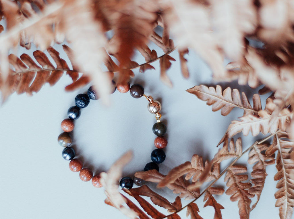 1. Natural Lava Bracelet Magic Autumn by Canary Lava, featuring polished lava rocks, hematite, Indian agate, and goldstone beads, styled with autumn leaves