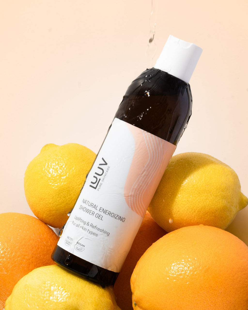 1. LUUV Natural Refreshing Carrot Shower Gel bottle surrounded by fresh citrus fruits on a light background