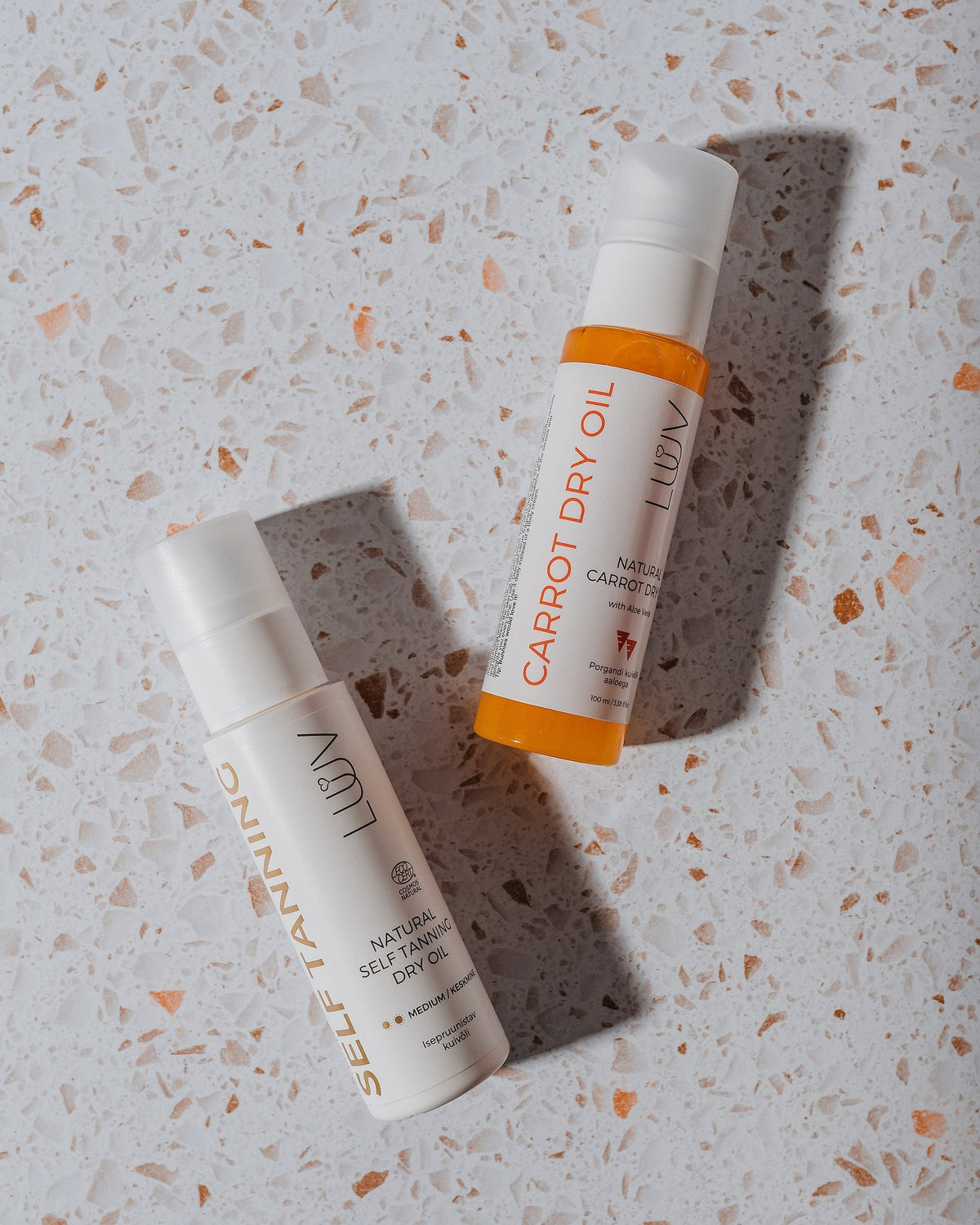 5. Studio image of LUUV Natural Self Tanning Dry Oil with packaging, highlighting product details