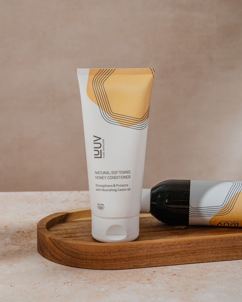 1. LUUV Natural Softening Honey Conditioner, 200ml, displayed on a wooden tray in a lifestyle setting