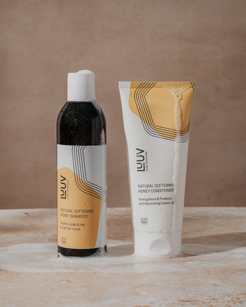 1. LUUV Natural Softening Honey Shampoo and Conditioner Set on textured surface, showcasing eco-certified packaging