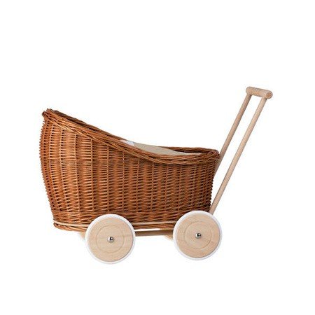 2. Side view of natural wicker doll pram with beige bedding and wooden wheels