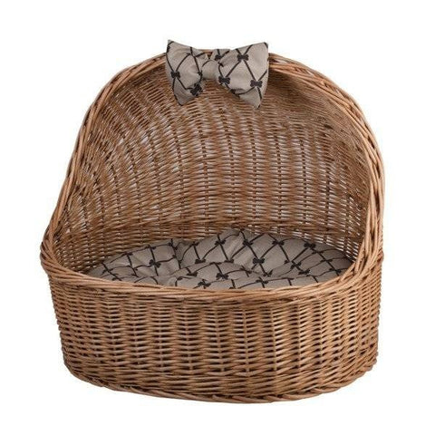 5. Angled front view of natural wicker pet house with patterned cushion and bow
