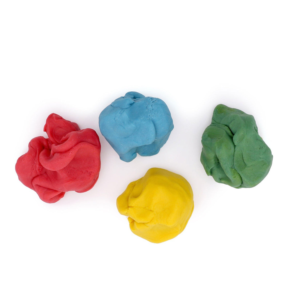 4. Flat lay of Neogrün Easy Clay in red, blue, yellow, and green, shaped into balls