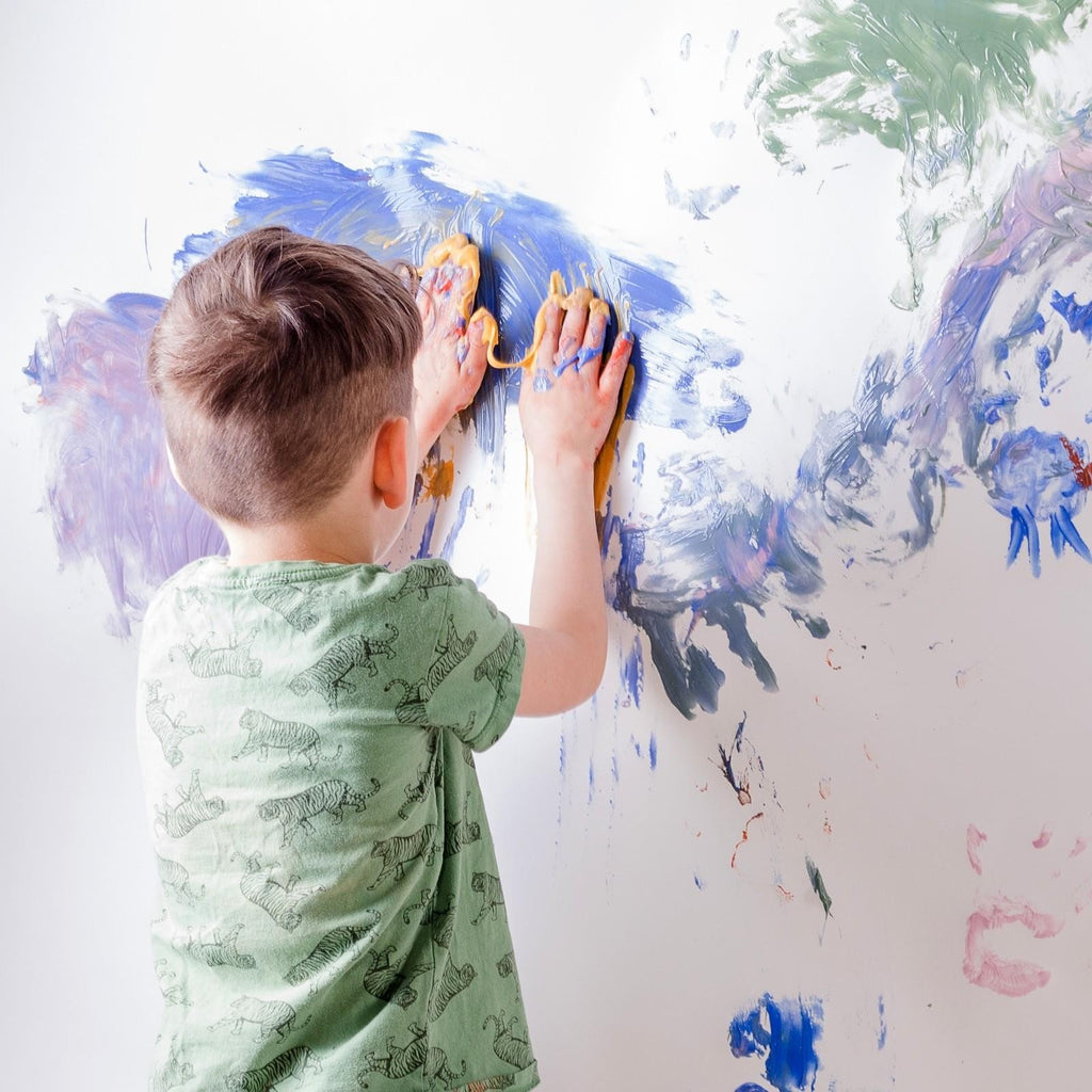 3. Close-up of Neogrün finger paint jars with creamy texture in yellow, red, blue, and green