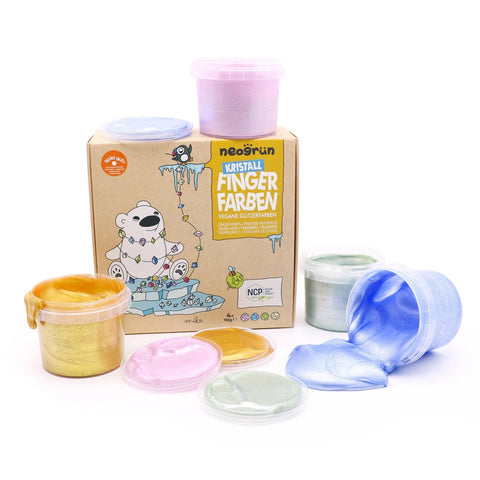 1. Neogrün organic glitter finger paint set with open containers of Rose Quartz, Sapphire, Jade, and Gold colors next to a decorated box featuring a polar bear illustration