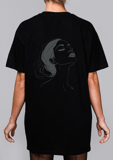 3. Woman shown from back wearing black T-shirt with subtle black line art illustration on grey background