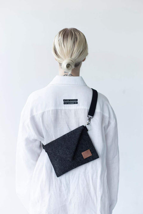 2. Women's Skive-mini crossbody bag by Nordhale worn on back, shown with white shirt in studio