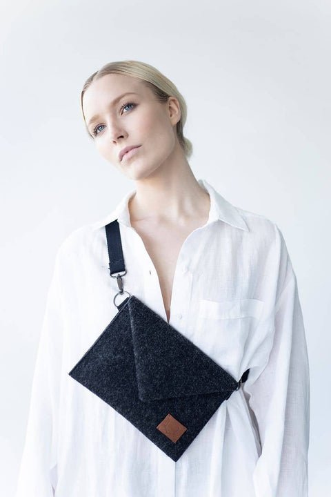 3. Women's Skive-mini crossbody bag by Nordhale worn over shoulder, shown with white shirt in studio
