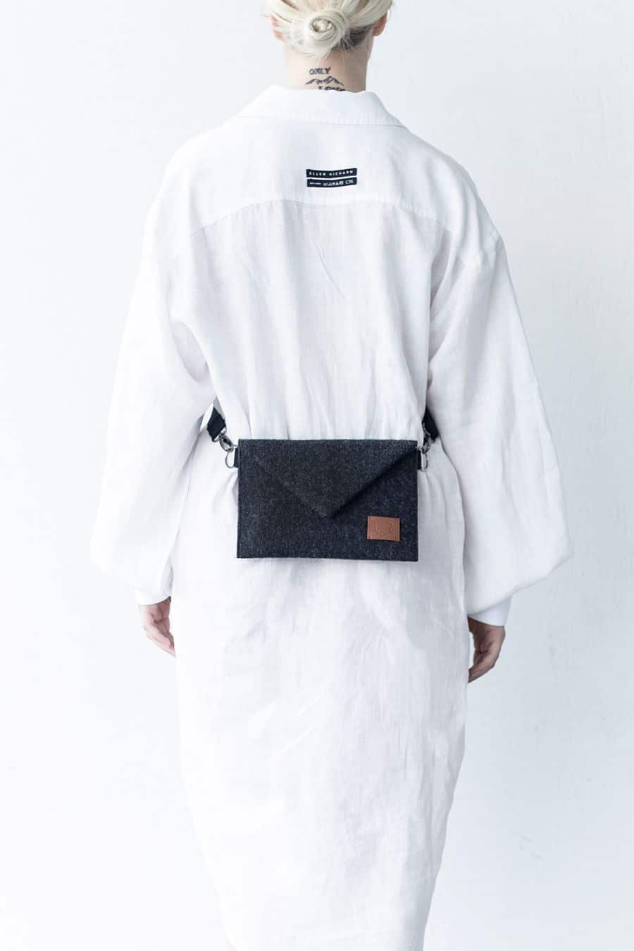 4. Women's Skive-mini crossbody bag by Nordhale worn on waist, shown with white shirt in studio