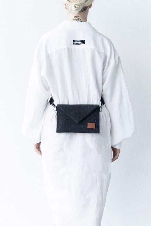 4. Women's Skive-mini crossbody bag by Nordhale worn on waist, shown with white shirt in studio