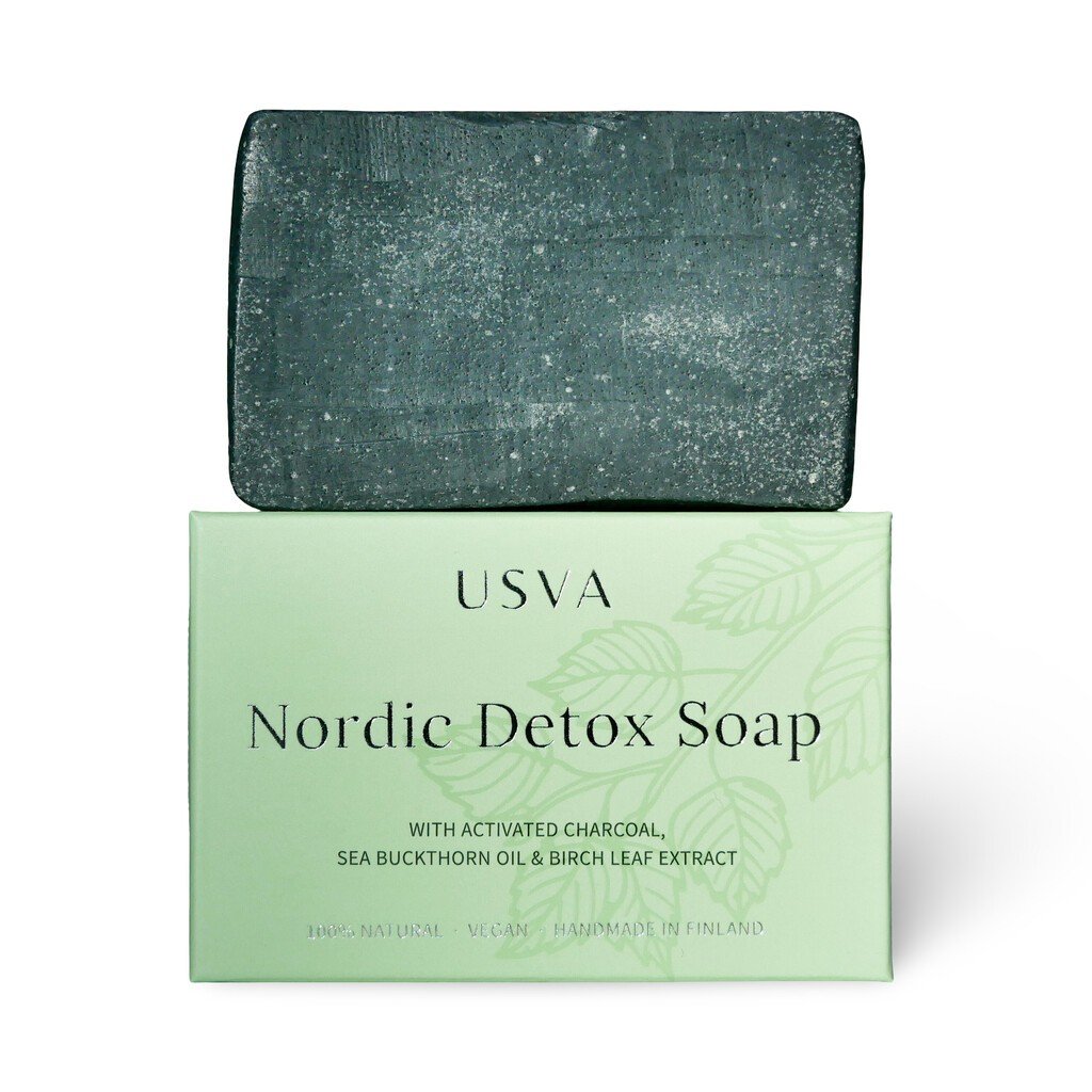 4. Nordic Detox Soap bar on top of its green packaging by Usva Cosmetics
