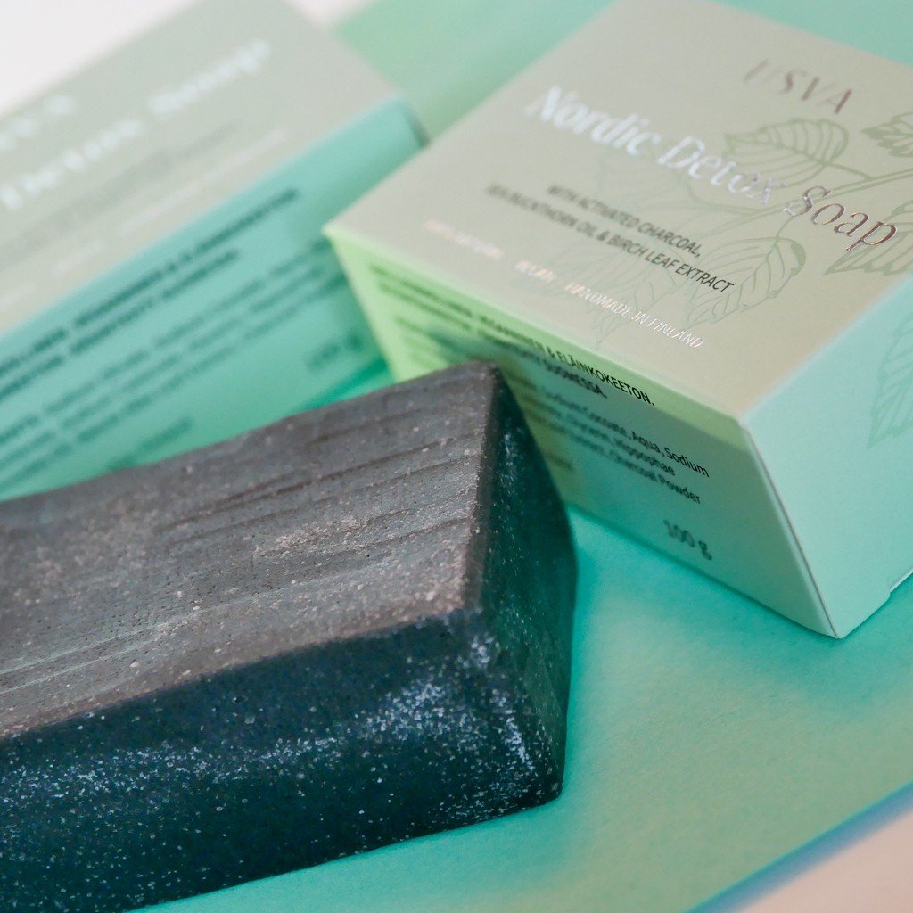 3. Close-up of Nordic Detox Soap bar and packaging by Usva Cosmetics on a teal surface