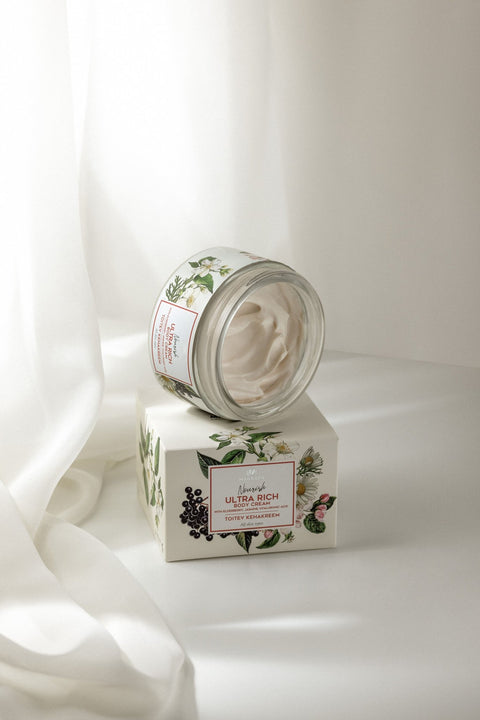1. Open jar of Magrada Organic Cosmetics Nourishing Body Cream with floral packaging on white fabric background