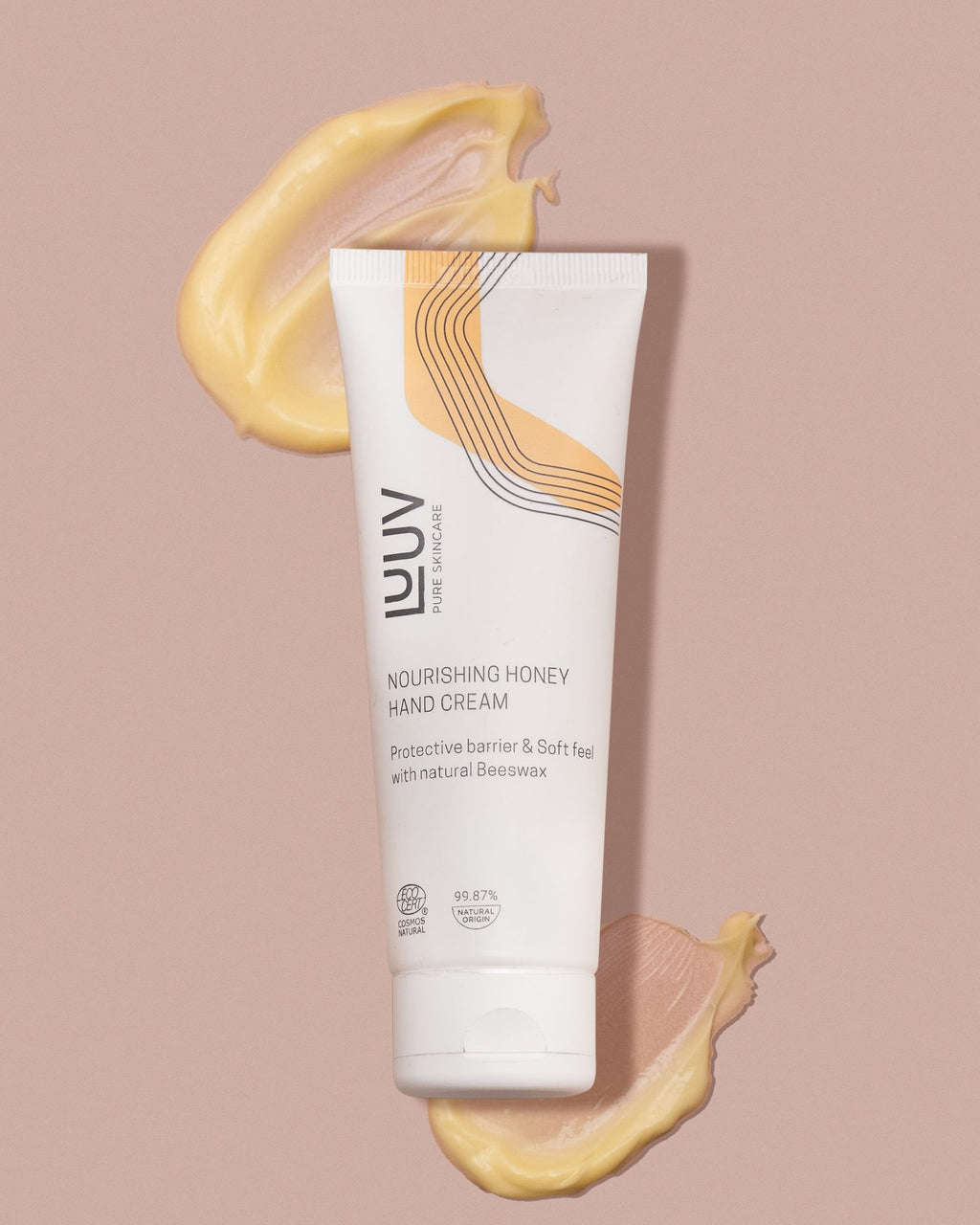 3. LUUV Nourishing Honey Hand Cream tube with honey-colored cream swirls, emphasizing texture and natural ingredients