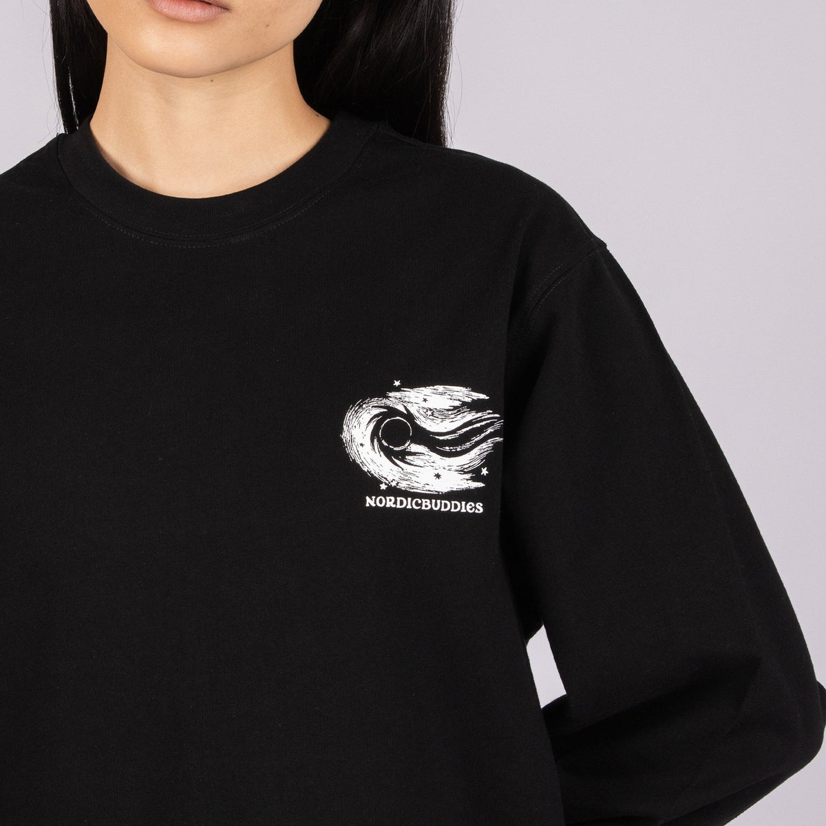 6. Close-up of Moomin by NordicBuddies logo on black longsleeve shirt, highlighting detailed illustration