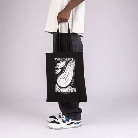 1. Unisex black Moomin Novels Tote Bag held by a model, featuring Pyrstötähti design, in studio setting