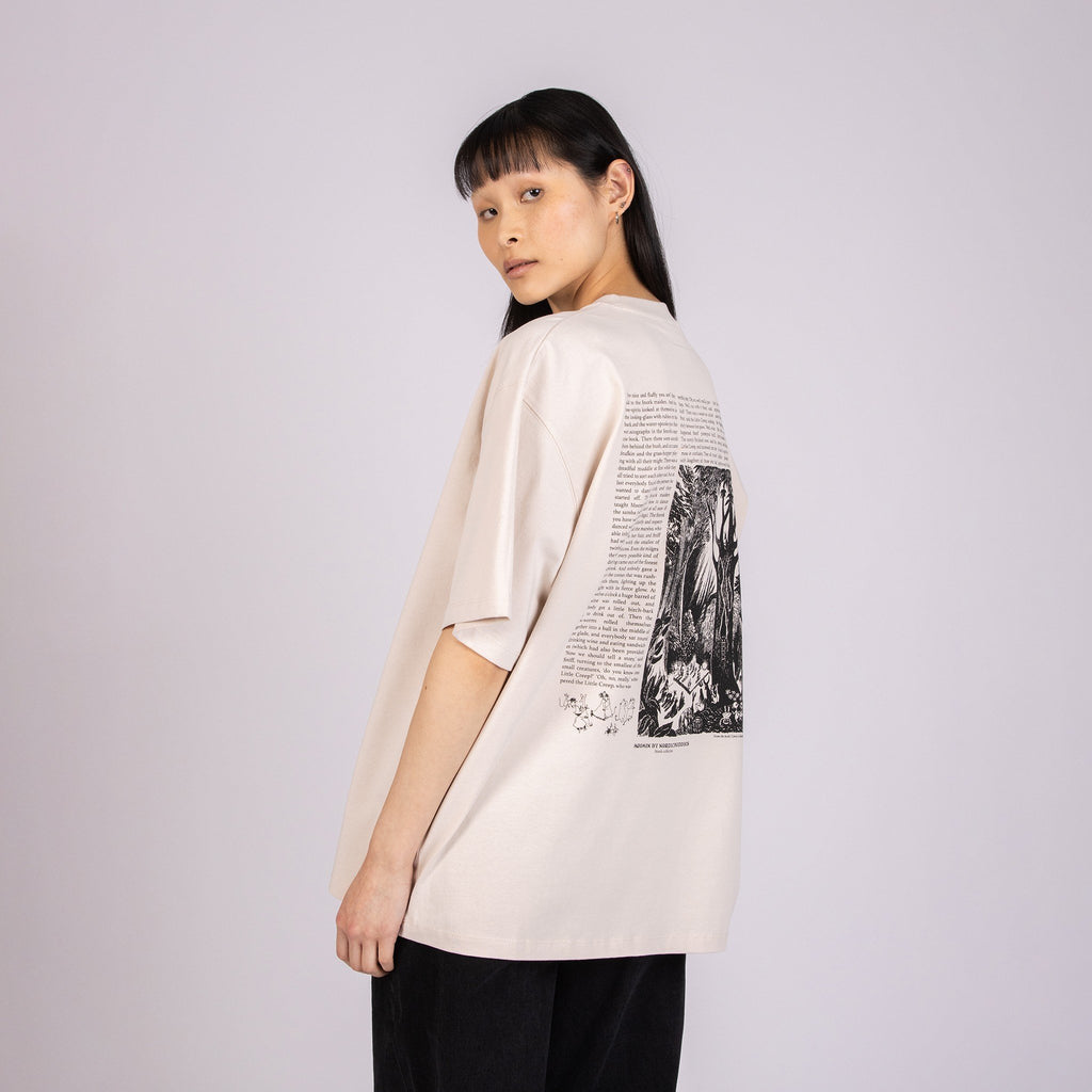 4. Female model wearing unisex beige Moomin t-shirt, highlighting back design with text and illustration