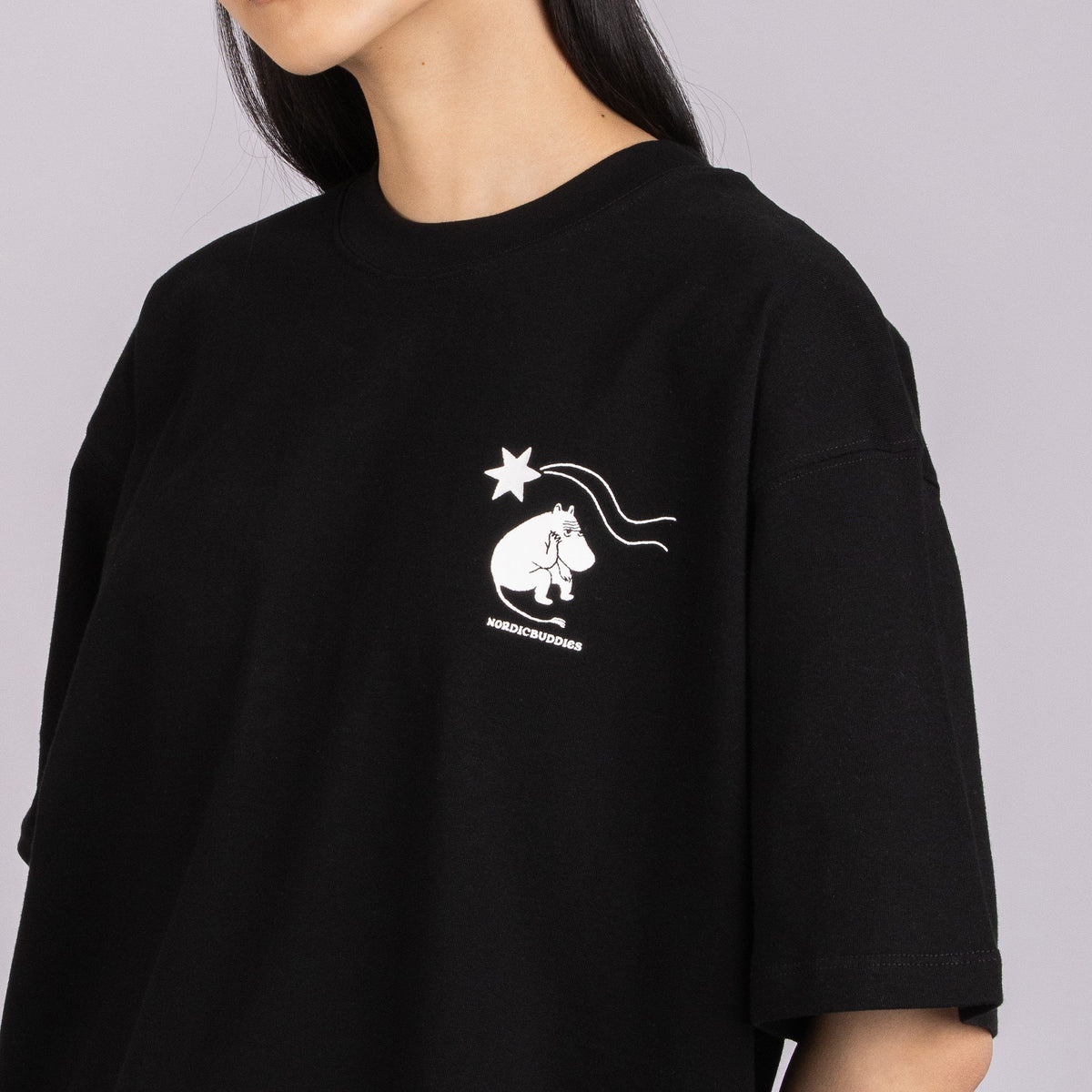 5. Close-up of black Moomin t-shirt showing front logo and organic cotton fabric