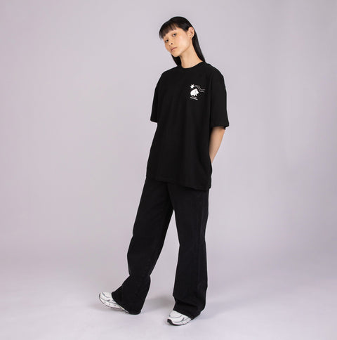 4. Female model in black Moomin t-shirt with subtle front logo, styled casually in studio