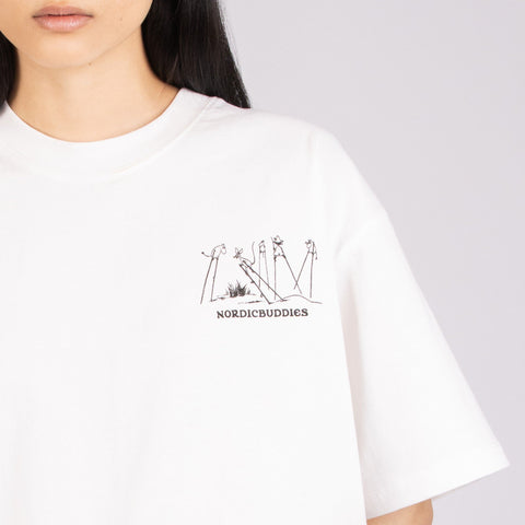 3. Close-up of NordicBuddies logo on front of unisex white Moomin t-shirt, worn by female model