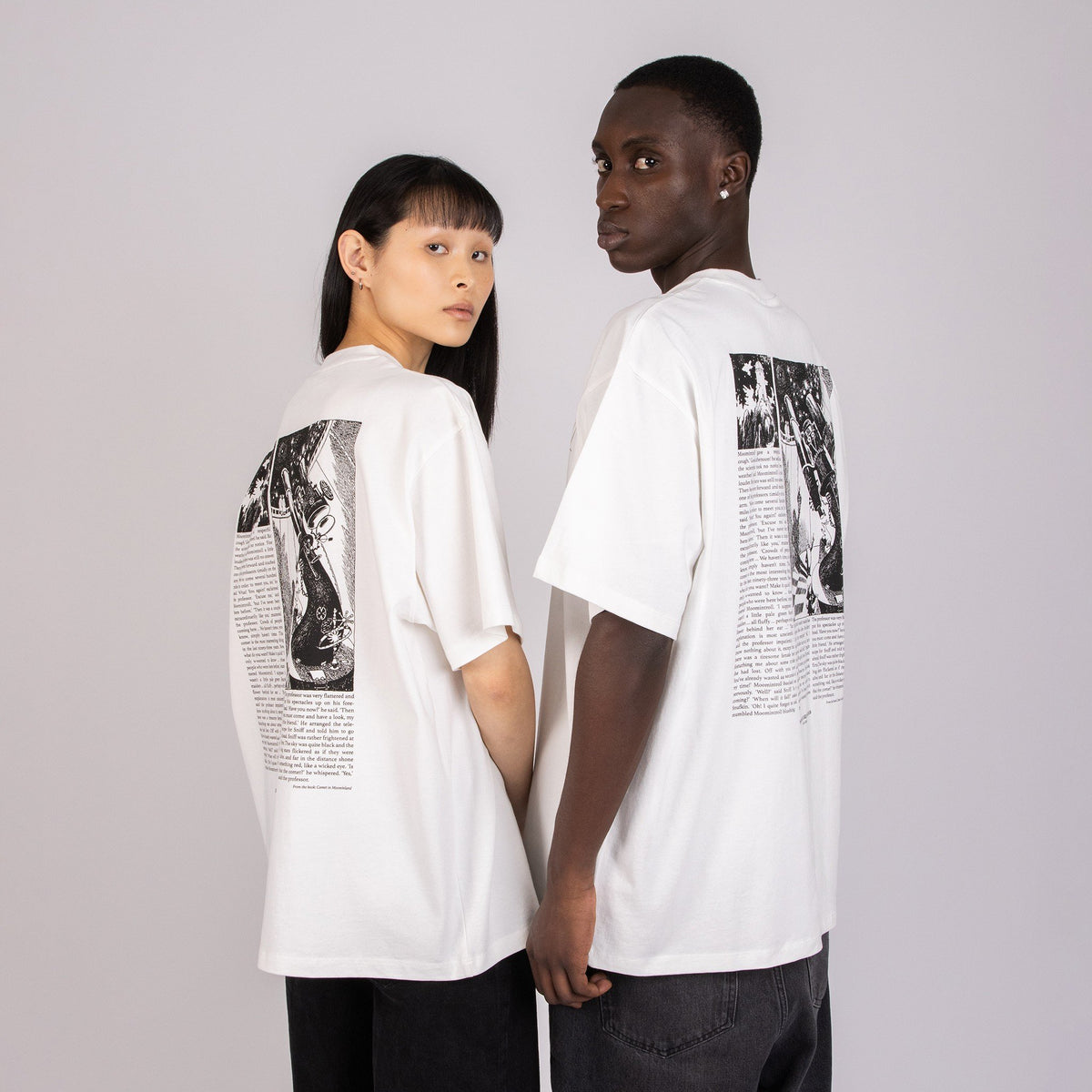 1. Unisex white Moomin t-shirt worn by male and female models, showing back design in studio setting