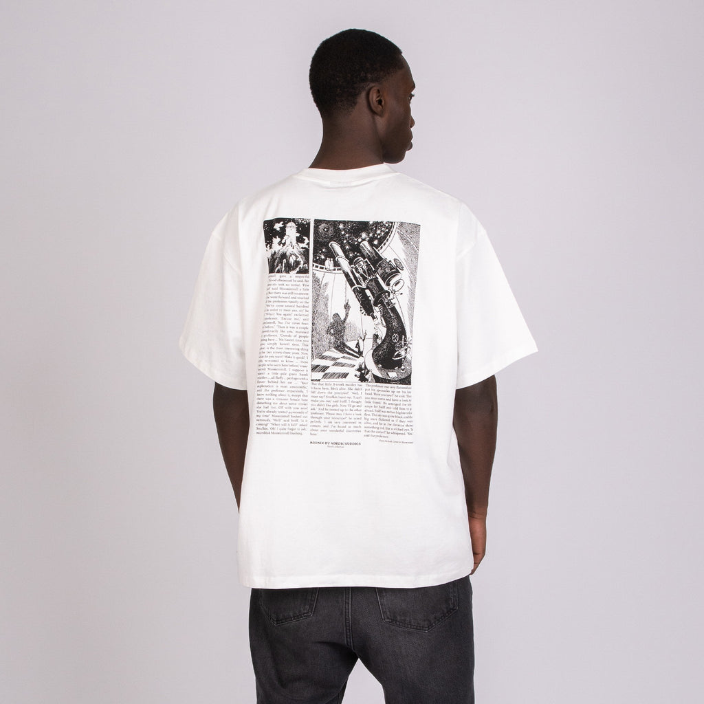 5. Male model wearing unisex white Moomin t-shirt, highlighting back design in studio setting