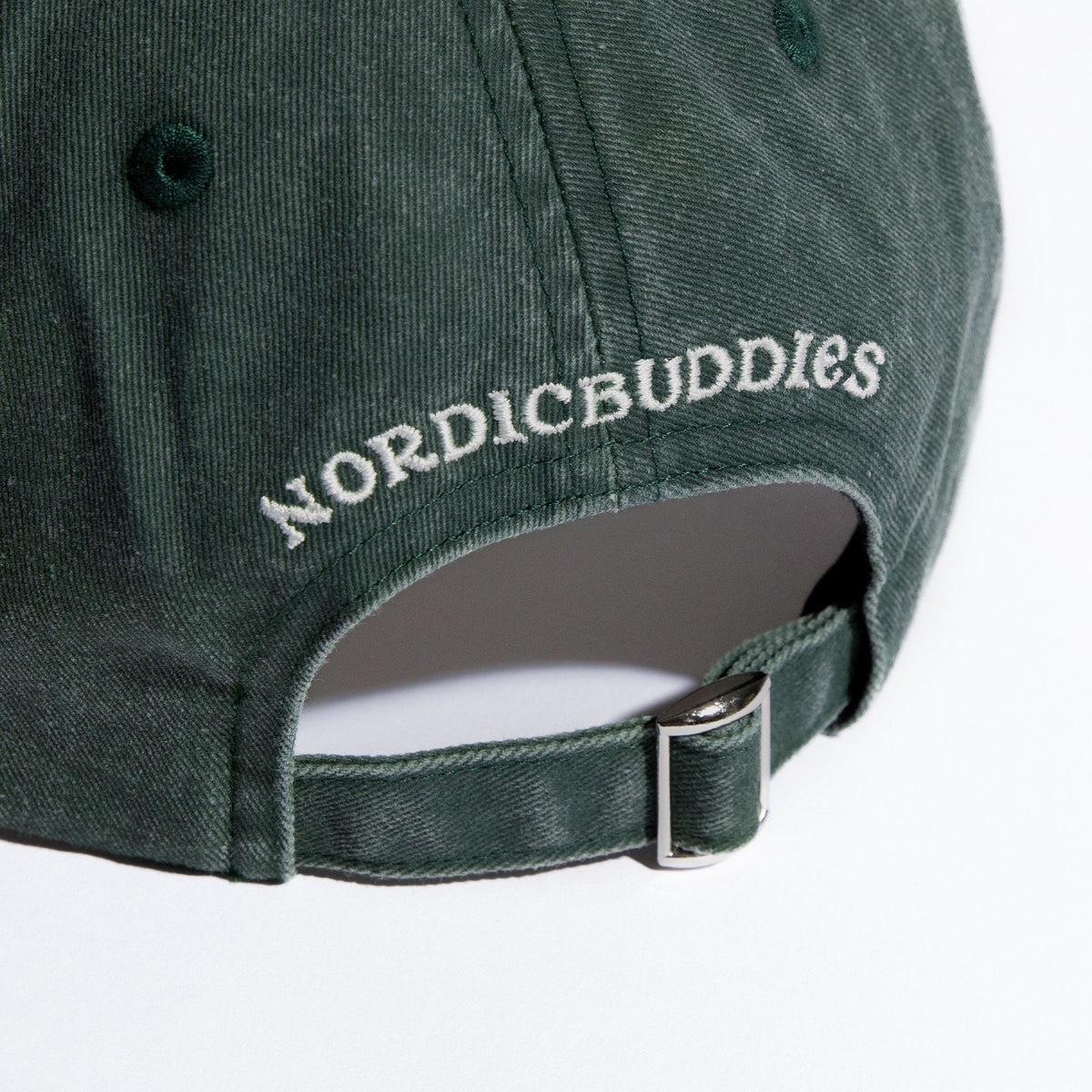 6. Close-up of NordicBuddies branding and adjustable strap on green Moomin cap