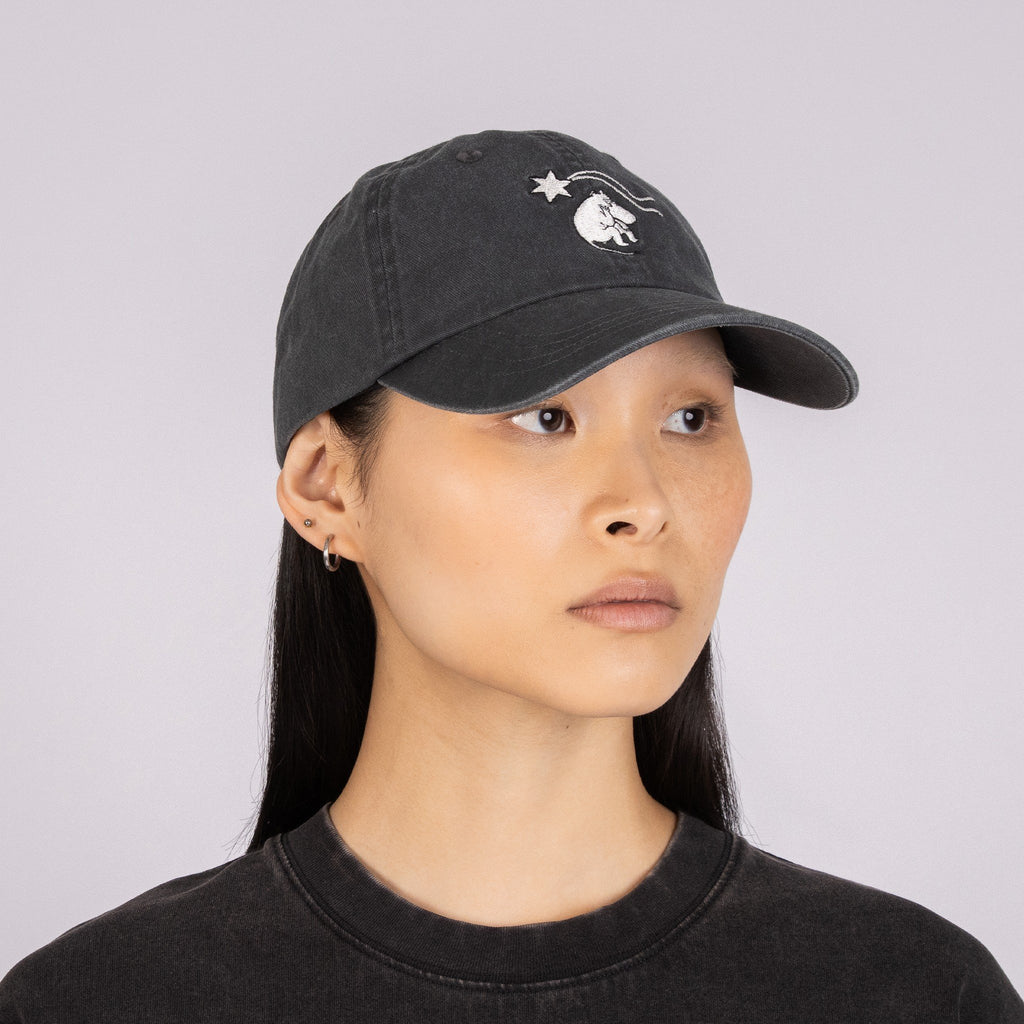 2. Woman in profile wearing Moomin by NordicBuddies grey denim cap with Moomin embroidery
