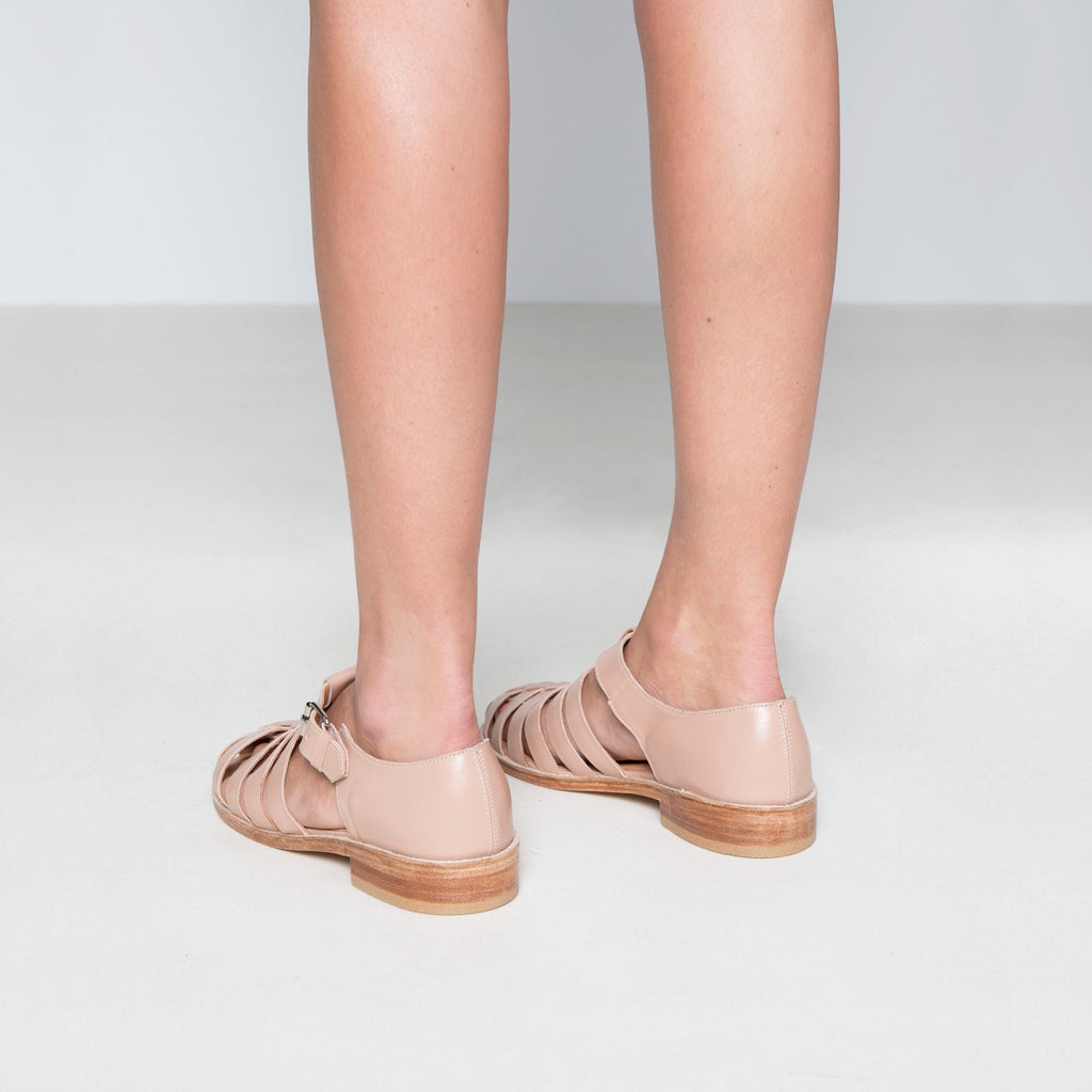 3. Back view of women's nude leather fisherman sandals by Daz Studio, highlighting stacked leather heel