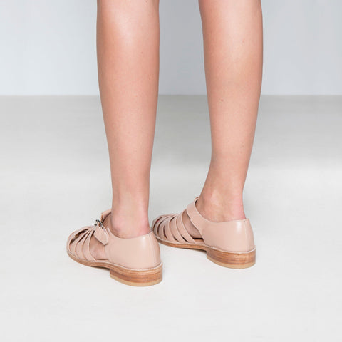 1. Women's beige leather fisherman sandals by Daz Studio, shown from the back in a lifestyle setting