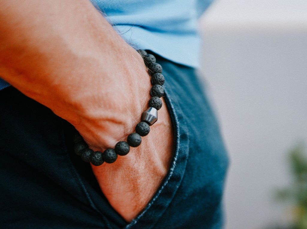 1. Men's Obsidian Lava Stone Bracelet by Canary Lava worn on wrist, showcasing polished lava rocks and Obsidian stone
