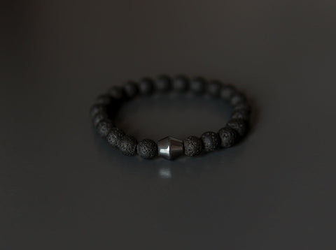 2. Studio image of Obsidian Lava Stone Bracelet by Canary Lava, featuring polished lava rocks and central Obsidian stone