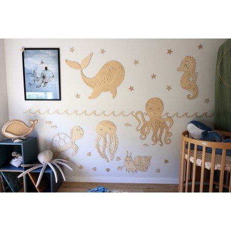 2. Ocean-themed nursery with wooden wall decorations including octopus, whale, and seahorse, creating a playful marine environment
