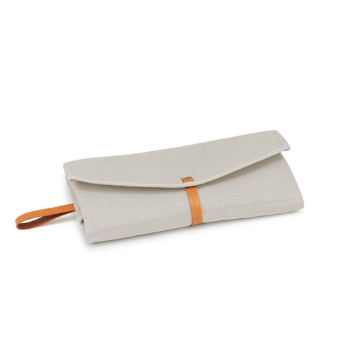 2. Beige Okka travel mat folded with brown leather strap on white background