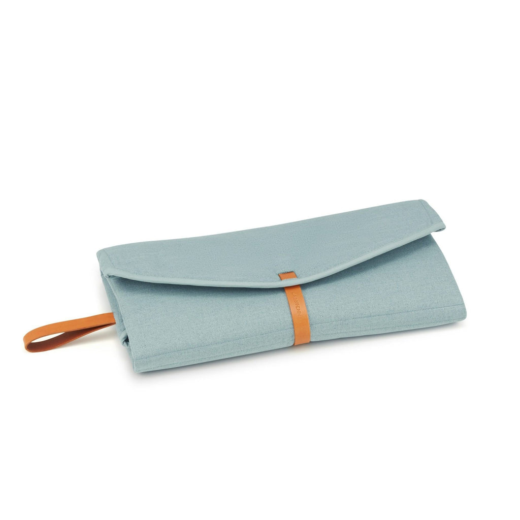 2. Folded Okka travel mat in soft teal with brown leather strap on white background