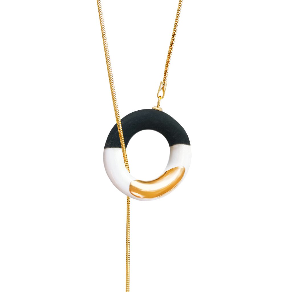 3. Studio image of SCULP Big OM Choker featuring a black and white ceramic pendant with 24K gold accents on a gold-over-925 sterling silver chain