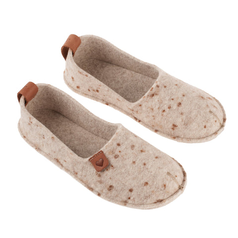 2. Pair of women's beige felt slippers by Omaking with rubber sole, displayed in studio