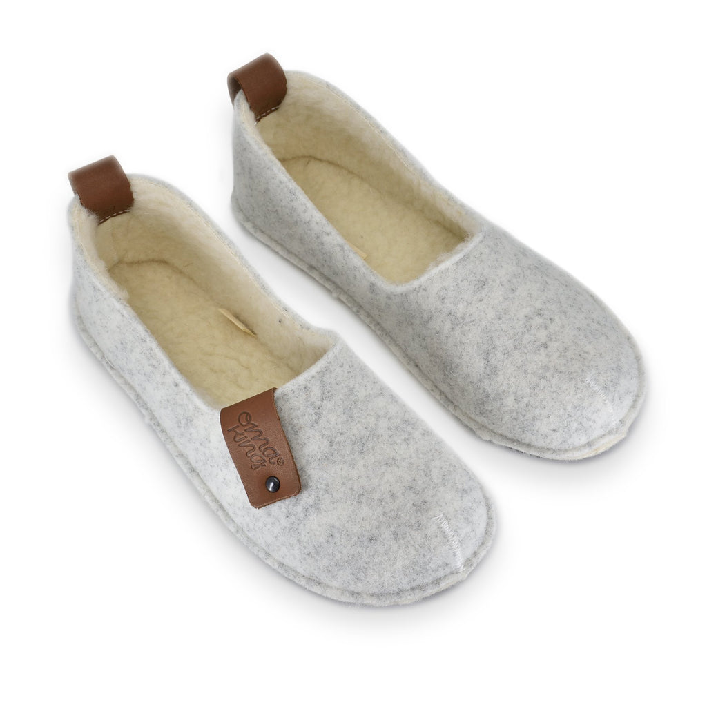 2. Pair of women's white Toku slippers by OmaKing, highlighting natural felt and lambswool lining, studio shot