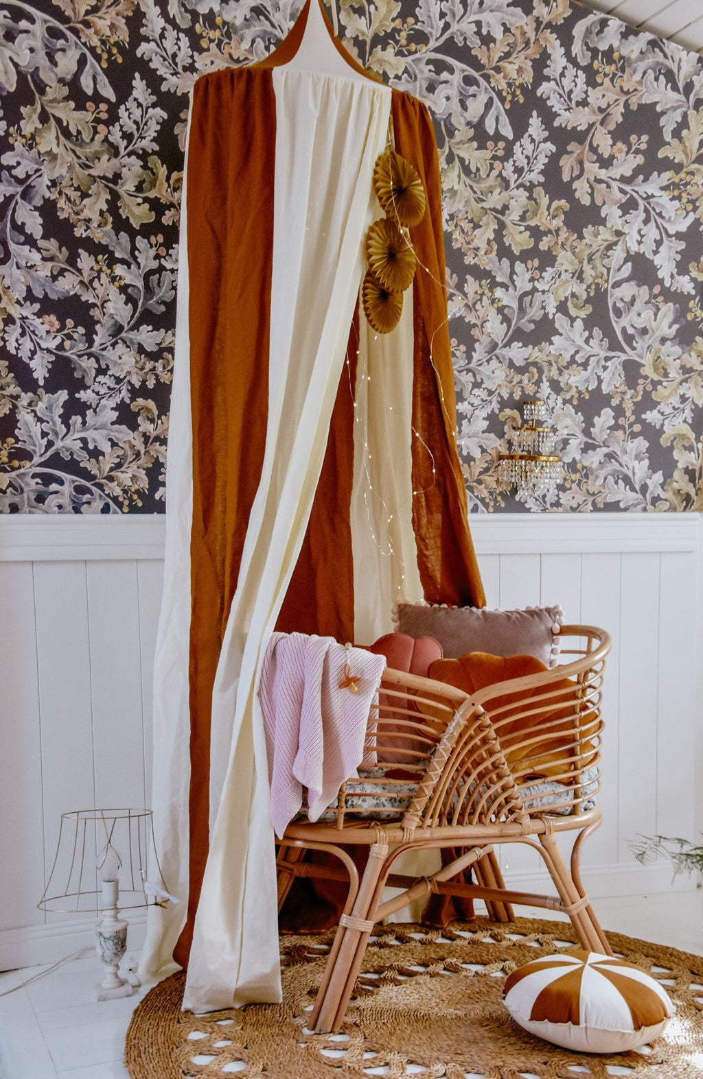 5. Caramel and cream canopy with wicker chair and floral wallpaper in a cozy room