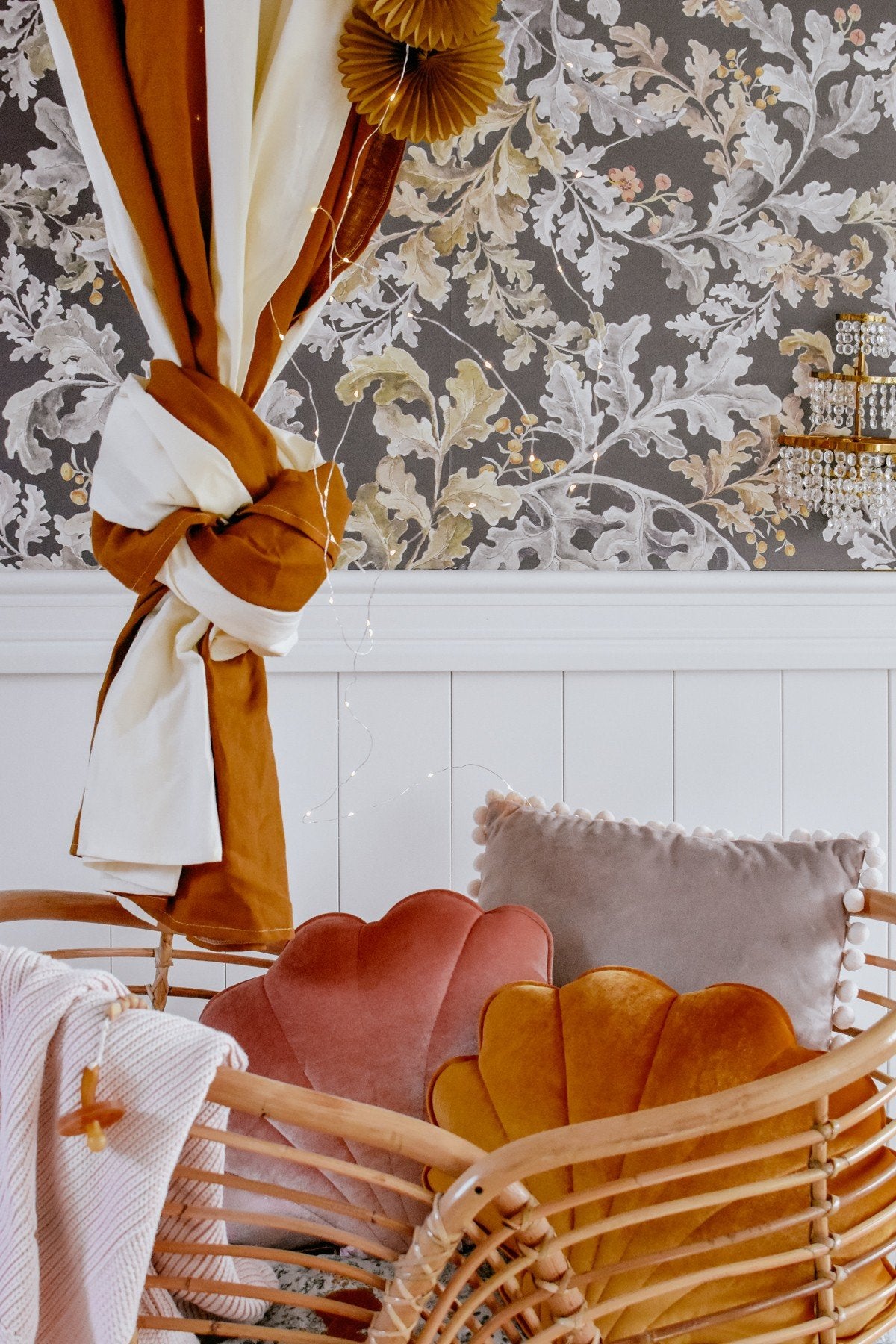 3. Close-up of caramel and cream canopy tied with decorative elements against floral wallpaper