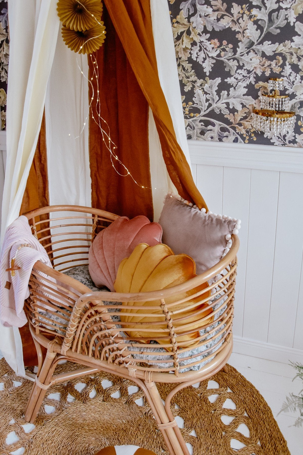 14. Close-up of wicker chair with cushions under caramel and cream canopy
