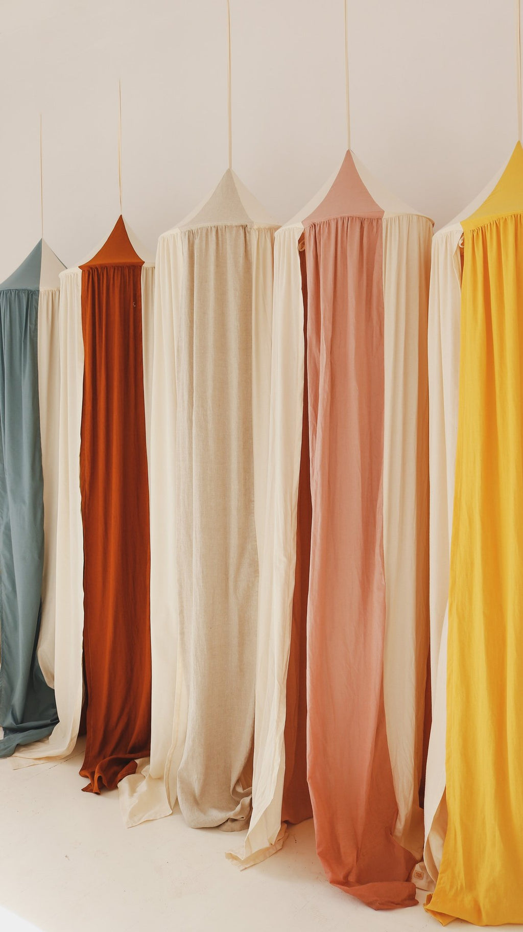 12. Close-up of five colorful canopies in cream, blue, orange, pink, and yellow