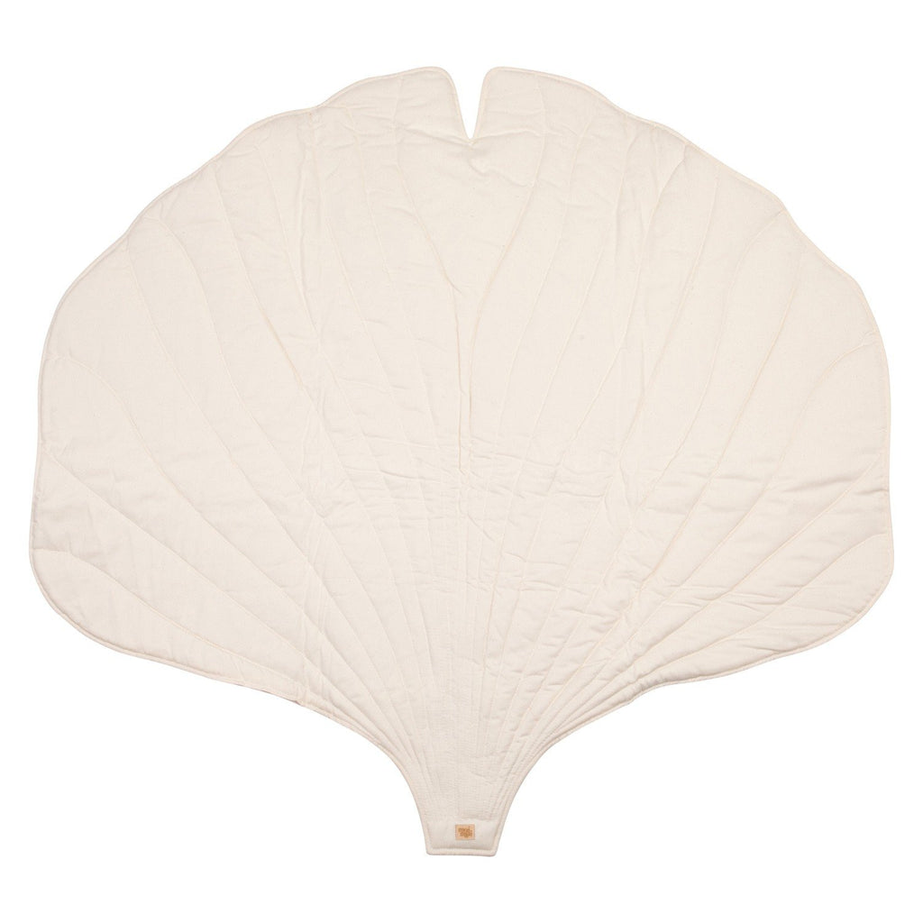 4. Flat lay of cream ginkgo leaf-shaped playmat made from organic cotton and velvet, showing quilted texture and unique leaf design