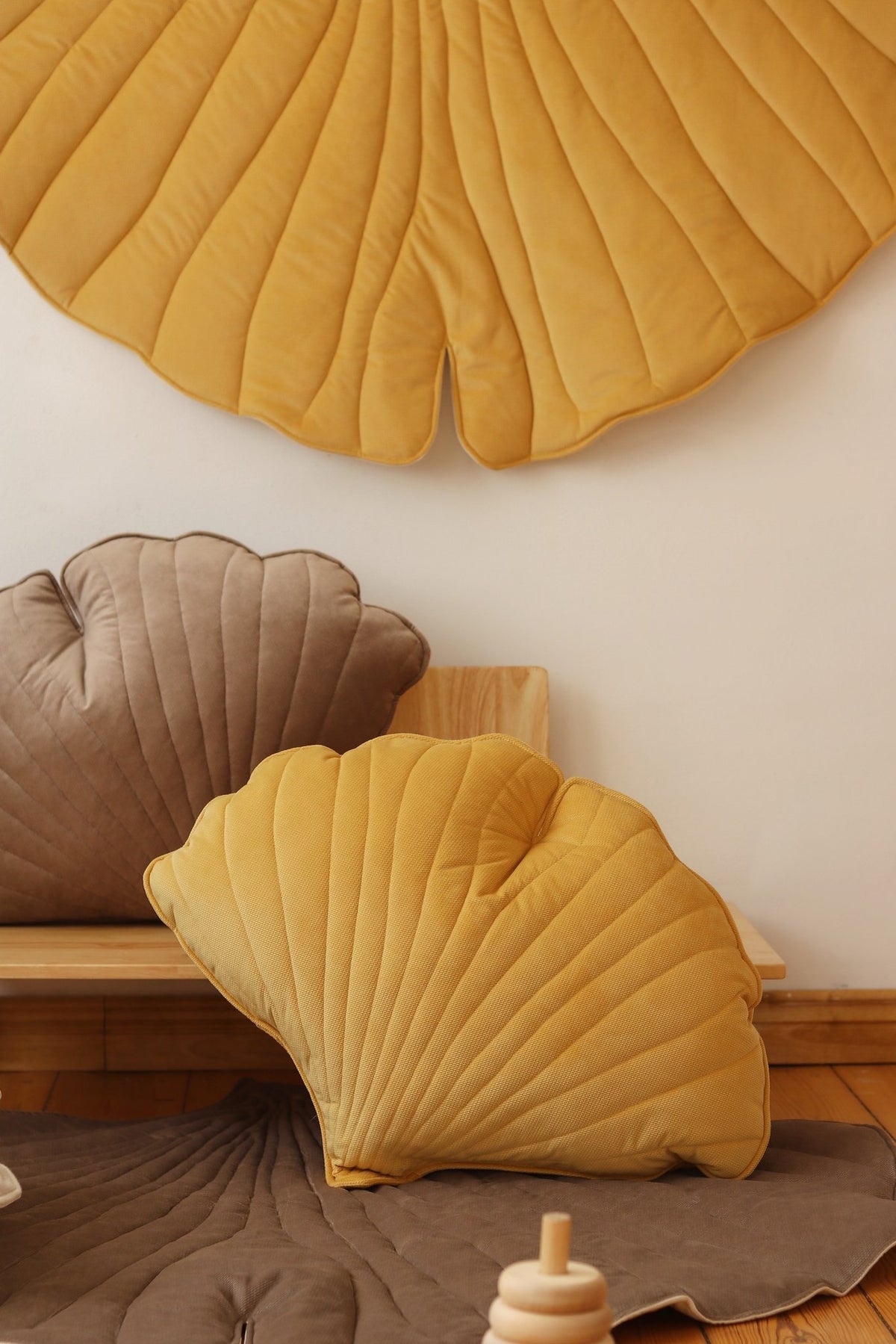 5. Close-up of yellow ginkgo leaf playmat with matching cushions in a cozy setting