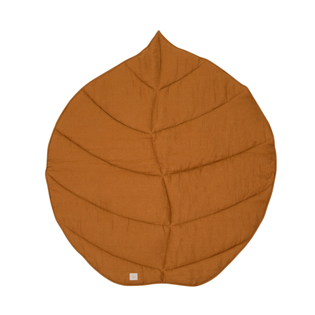 2. Caramel-colored ginkgo leaf-shaped playmat made from organic cotton and linen on a white background