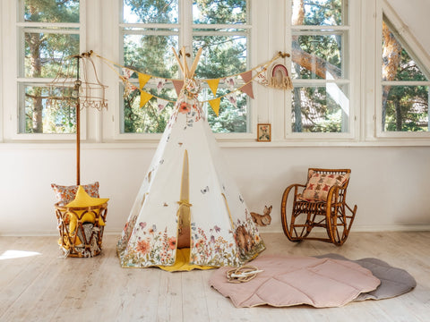 1. Powder pink leaf playmat in a children's room with a floral teepee and wooden rocking chair